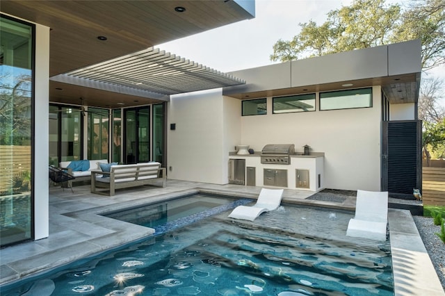 back of property featuring an outdoor living space, a jacuzzi, a patio area, and exterior kitchen