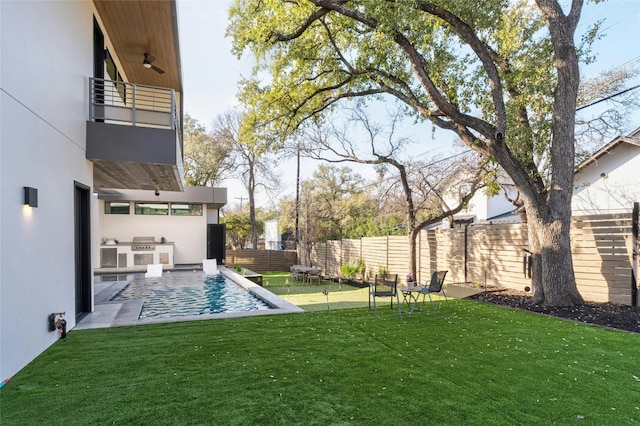 view of yard featuring area for grilling, a fenced in pool, a balcony, and a patio