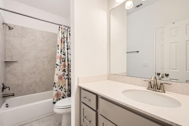 full bathroom featuring vanity, shower / bathtub combination with curtain, tile patterned floors, and toilet