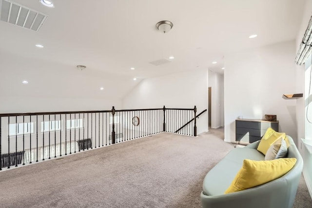 living area featuring vaulted ceiling and light colored carpet