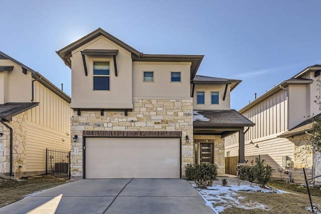 205 Audie Murphy Cir, Leander, TX 78641 - view of front of home with stone siding, concrete driveway, an attached garage, stucco siding, and central AC
