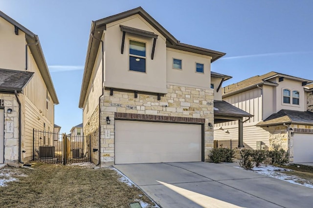 view of front of home featuring central AC unit and a garage