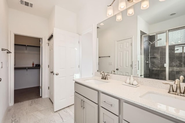 205 Audie Murphy Cir, Leander, TX 78641 - full bathroom featuring double vanity, a stall shower, a spacious closet, and marble look tile flooring