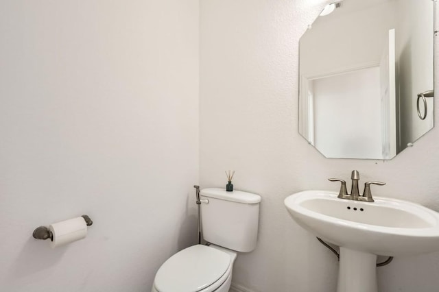 bathroom featuring sink and toilet