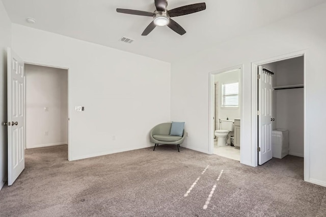 unfurnished bedroom with ensuite bath, light colored carpet, and ceiling fan