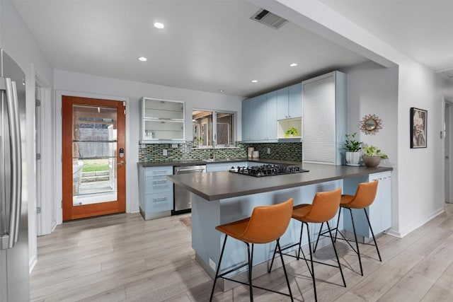 3601 Marcae Ct, Austin, TX 78704 - kitchen featuring stainless steel appliances, dark countertops, open shelves, healthy amount of natural light, and recessed lighting