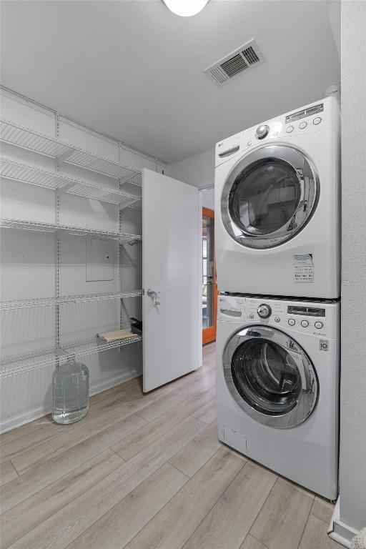 3601 Marcae Ct, Austin, TX 78704 - laundry area featuring estacked washer and dryer and wood finished floors