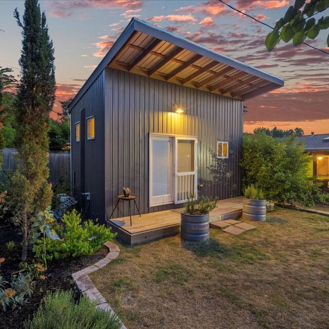 3601 Marcae Ct, Austin, TX 78704 - back of property at dusk featuring a yard and board and batten siding