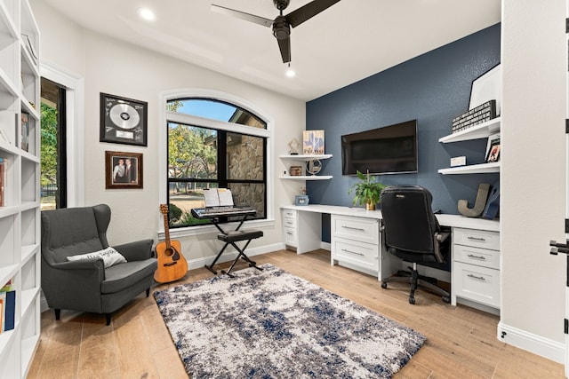 home office featuring a wealth of natural light, light hardwood / wood-style floors, and ceiling fan