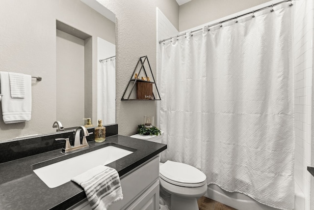 full bathroom with vanity, shower / tub combo with curtain, and toilet