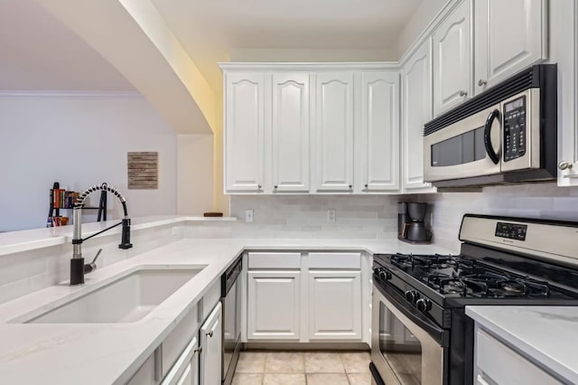 9525 N Capital Of Texas Hwy Unit 625, Austin, TX 78759 - kitchen featuring stainless steel appliances, white cabinets, backsplash, light stone countertops, and light tile patterned flooring