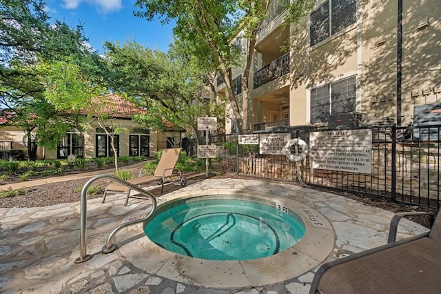 view of pool with a patio area and a community hot tub