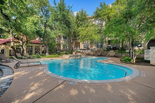 view of swimming pool featuring a patio area