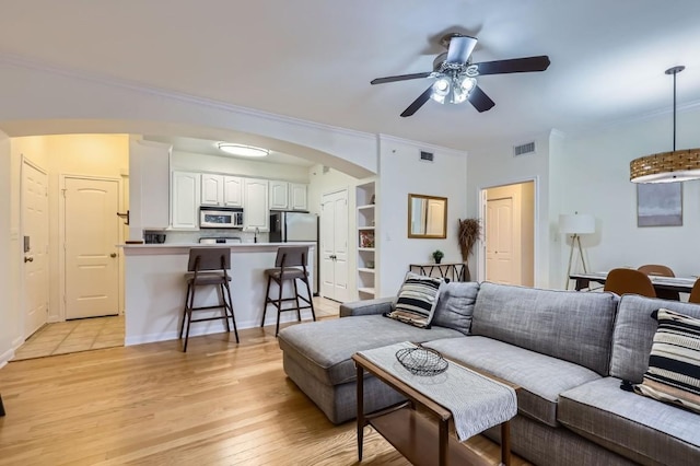 9525 N Capital Of Texas Hwy Unit 625, Austin, TX 78759 - living area with ceiling fan, arched walkways, light wood-type flooring, and ornamental molding