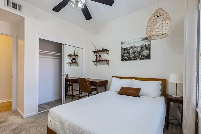 carpeted bedroom with ceiling fan and a closet