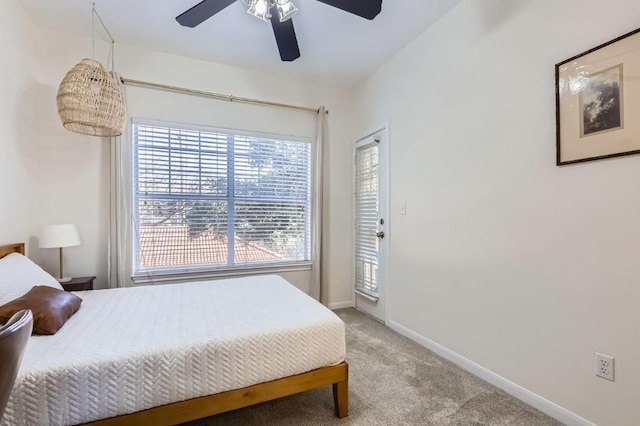 carpeted bedroom with ceiling fan and access to exterior