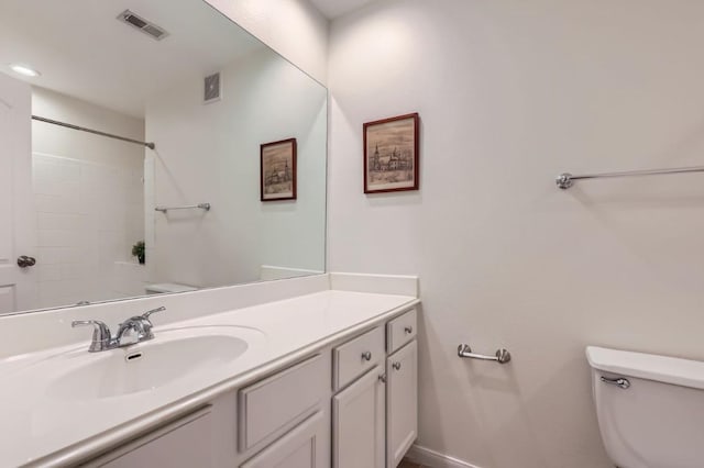 bathroom with vanity, toilet, and walk in shower