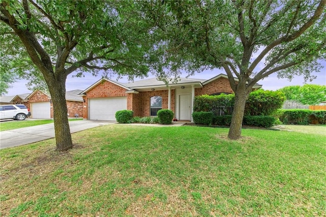 ranch-style house featuring a garage and a front yard