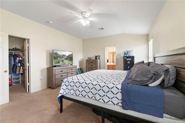 bedroom with ceiling fan, light carpet, a spacious closet, vaulted ceiling, and a closet