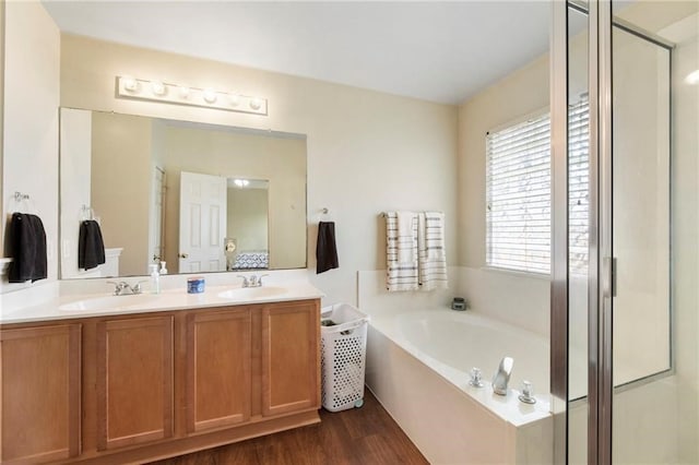 bathroom featuring vanity, separate shower and tub, and hardwood / wood-style floors