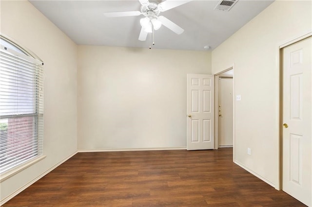 spare room featuring dark hardwood / wood-style floors and ceiling fan