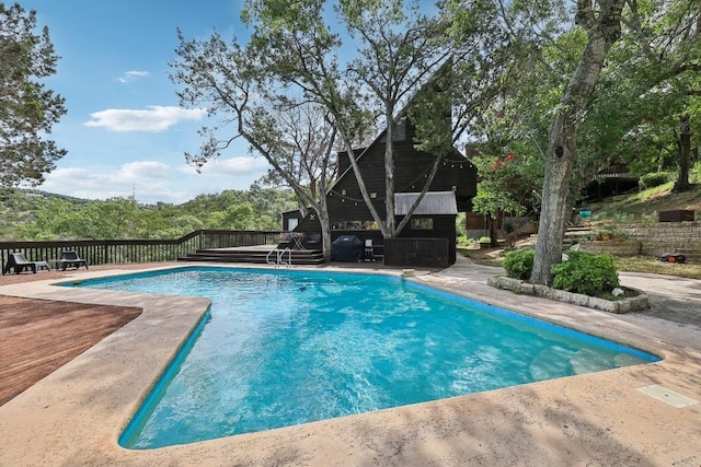 view of pool with a wooden deck