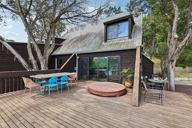 wooden terrace with a covered hot tub