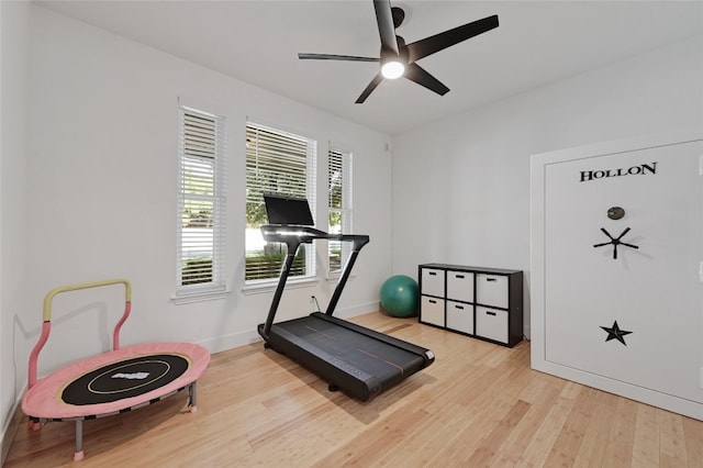 workout area featuring ceiling fan and light hardwood / wood-style flooring