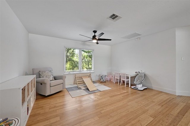 sitting room featuring ceiling fan and light hardwood / wood-style floors