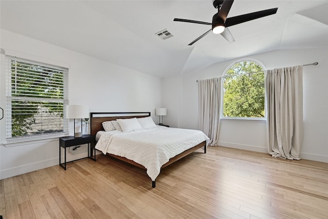 bedroom with ceiling fan, lofted ceiling, and light hardwood / wood-style floors