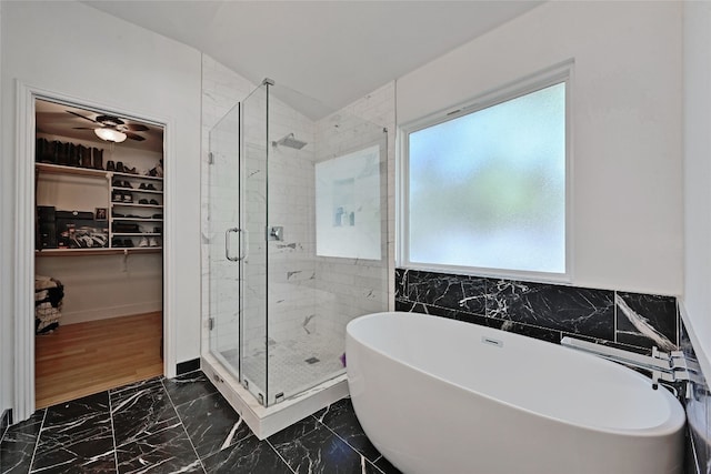 bathroom featuring shower with separate bathtub