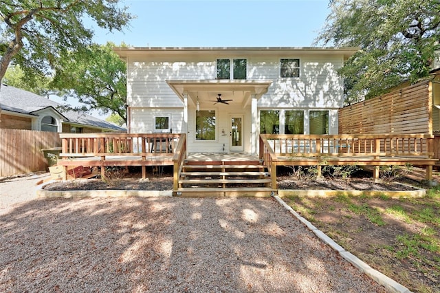 back of property with ceiling fan and a deck