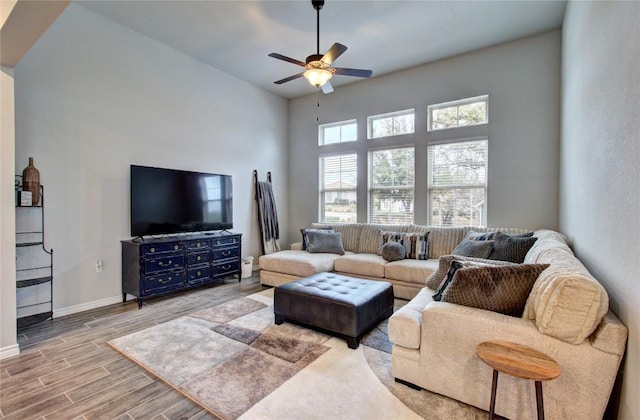 321 Dancing Oak Ln Unit 101, San Marcos, TX 78666 - living room with a ceiling fan, wood finished floors, and a towering ceiling
