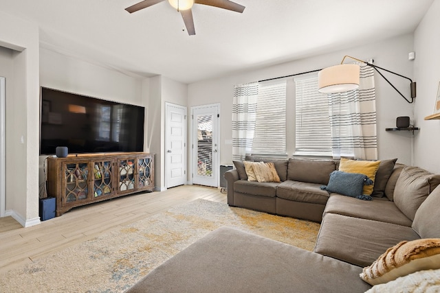 living room with ceiling fan and light hardwood / wood-style floors