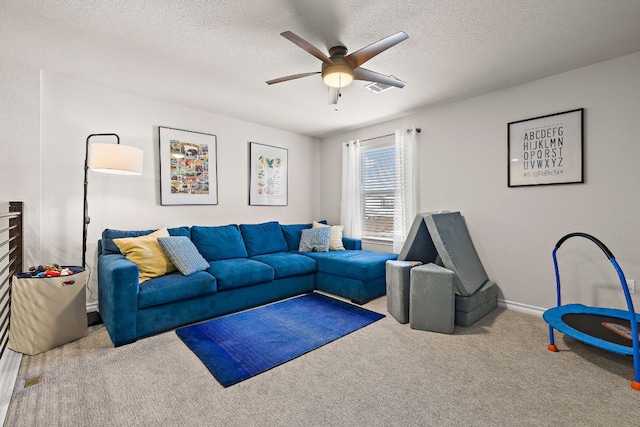 carpeted living room featuring a textured ceiling and ceiling fan