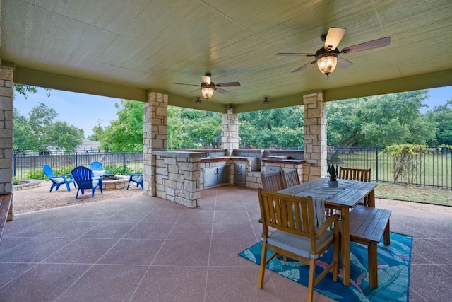 view of patio featuring ceiling fan and exterior kitchen