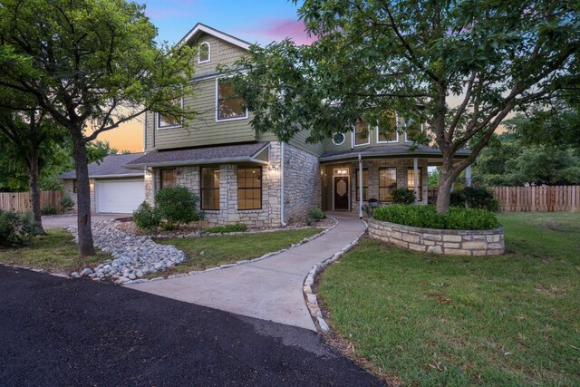139 Jackrabbit Run, Round Rock, TX 78664 - view of front of home featuring stone siding, a garage, covered porch, and concrete driveway