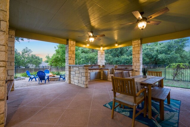 139 Jackrabbit Run, Round Rock, TX 78664 - fenced backyard featuring an outdoor fire pit, a patio area, an outdoor kitchen, outdoor dining space, and ceiling fan