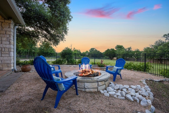 139 Jackrabbit Run, Round Rock, TX 78664 - yard at dusk with an outdoor fire pit
