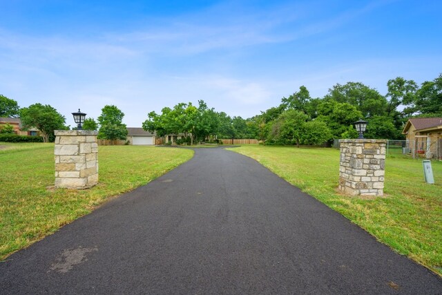 139 Jackrabbit Run, Round Rock, TX 78664 - view of asphalt driveway with street lighting