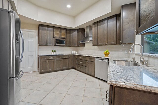 139 Jackrabbit Run, Round Rock, TX 78664 - kitchen with stainless steel appliances, wall chimney exhaust hood, a sink, light tile patterned flooring, and light stone counters