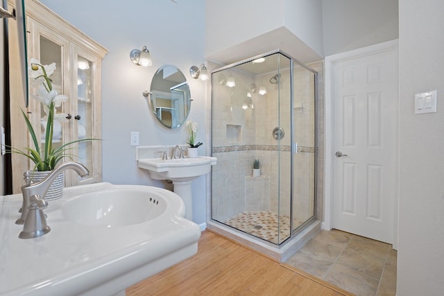 bathroom featuring hardwood / wood-style floors and a shower with door