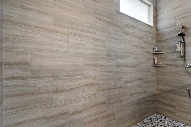 bathroom with tiled shower