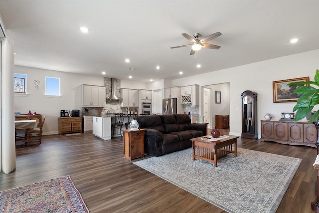 living room featuring dark hardwood / wood-style flooring and ceiling fan