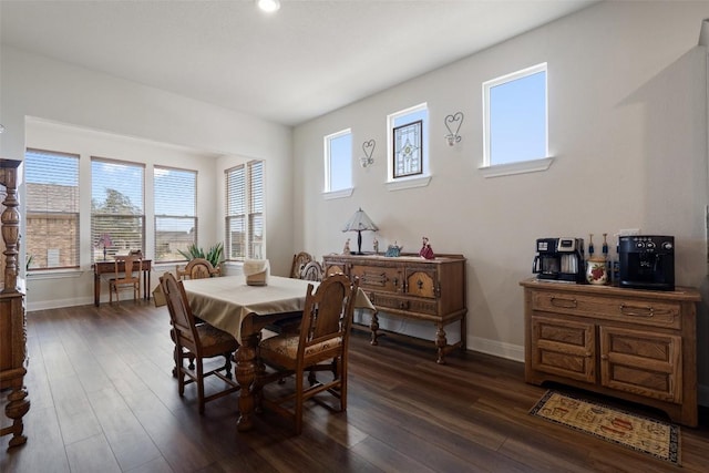 dining space featuring dark wood-type flooring and a healthy amount of sunlight