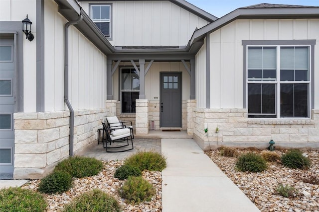 view of exterior entry with a porch