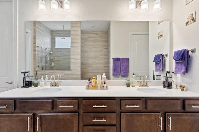 bathroom with vanity and tiled shower