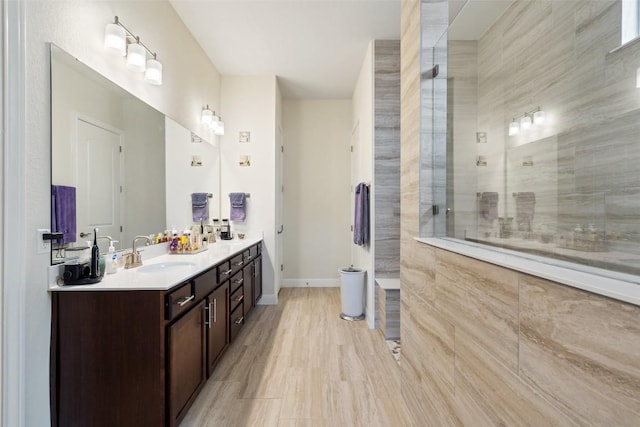 bathroom featuring vanity and tiled shower