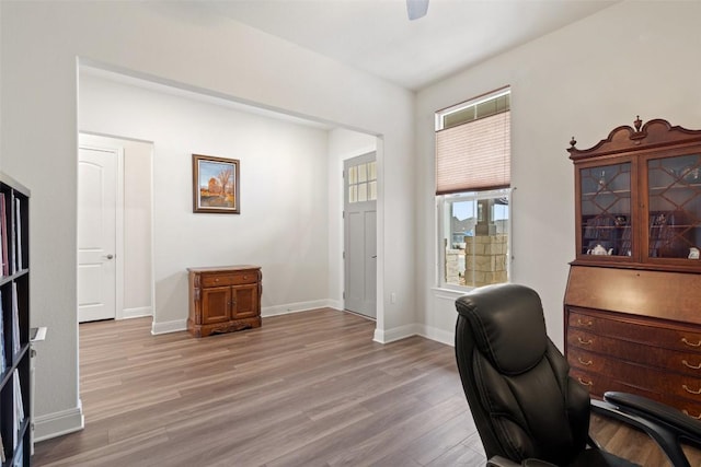 office area with ceiling fan and light hardwood / wood-style floors