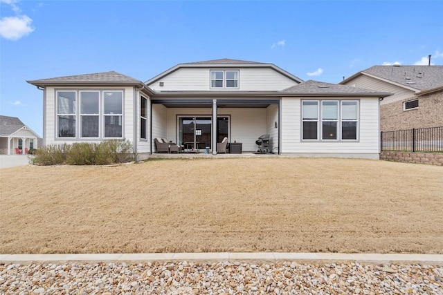 back of house with a yard and a patio area